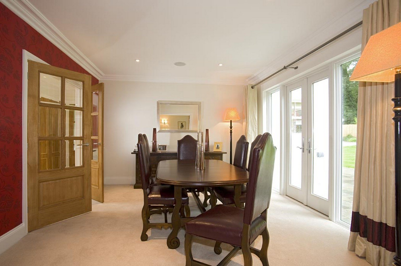 cream luxury carpet in dining room with french doors