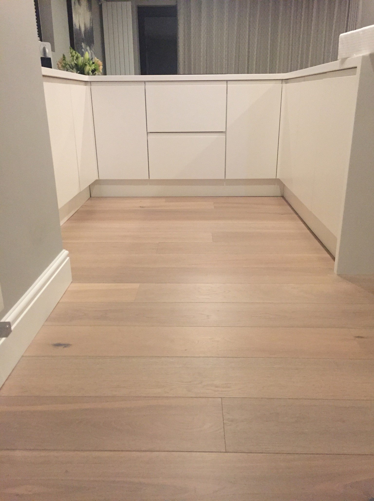 white washed engineered oak plank wood flooring in kitchen