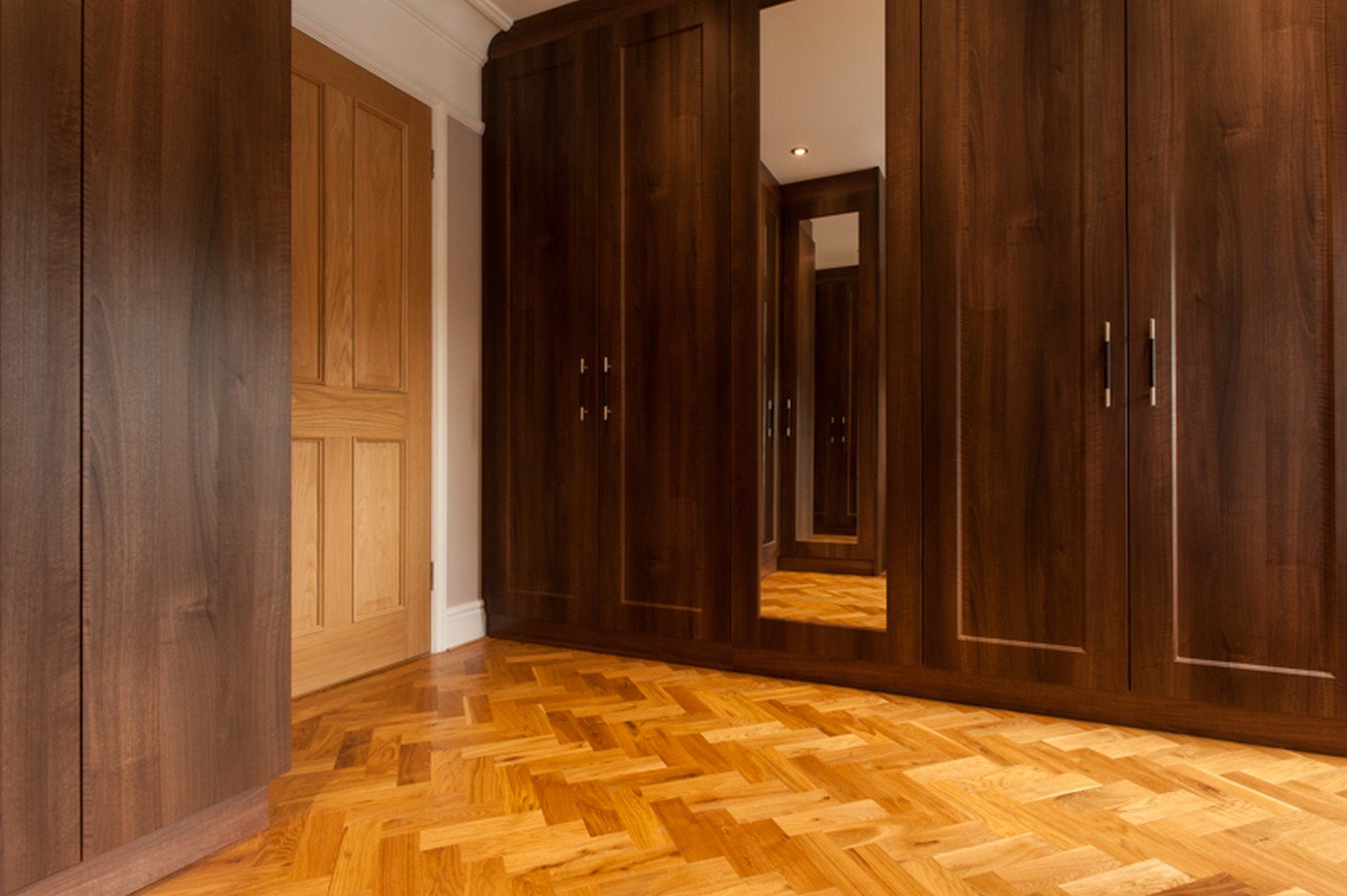 herringbone luxury wood flooring and wooden closets