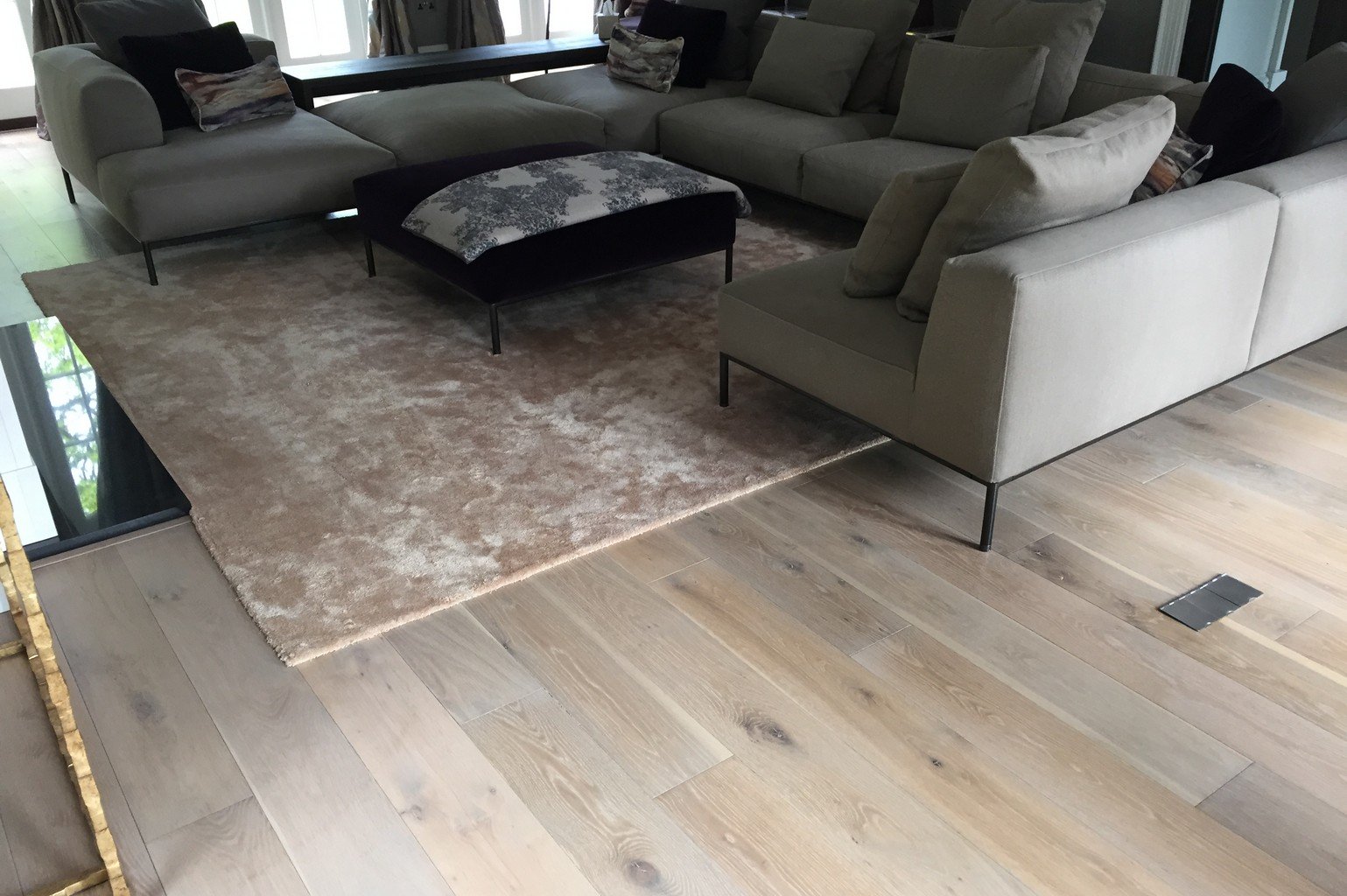 luxury wood flooring and pink faux silk rug